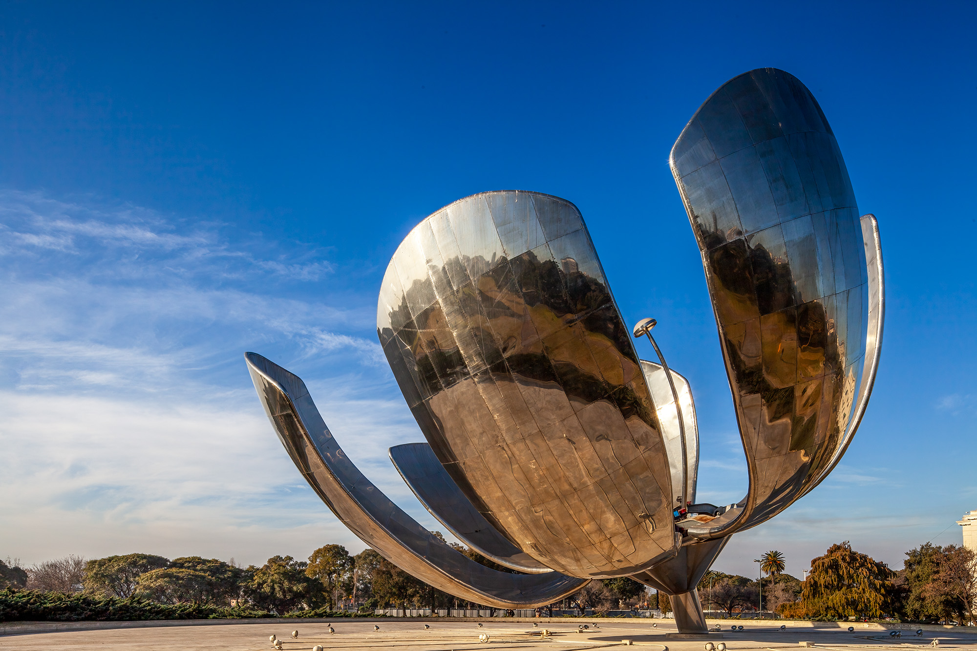 This photograph, captured in Buenos Aires, Argentina, beautifully showcases the iconic Floralis Generica sculpture. Rising tall...