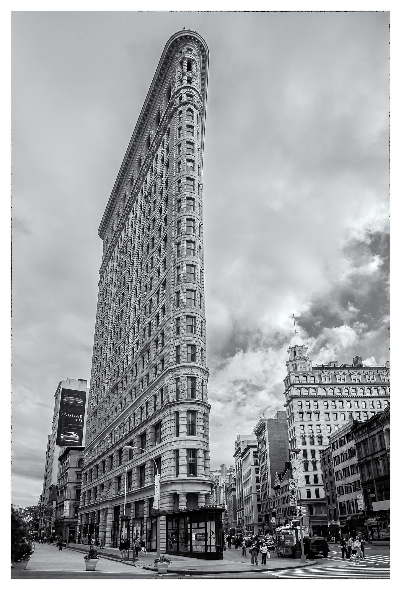 This striking vertical image, captured in New York City, showcases the iconic Flatiron Building in sharp black and white. The...