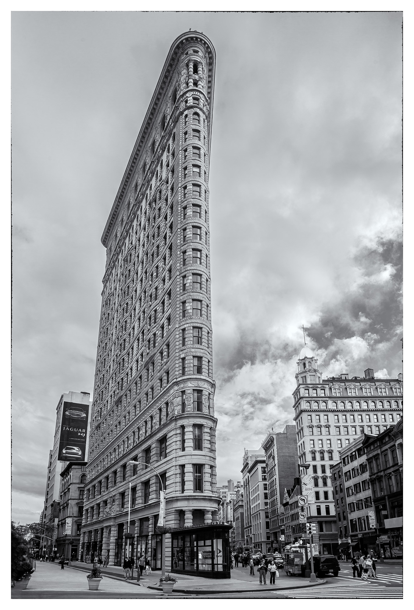Flatiron Building This striking vertical image, captured in New York City, showcases the iconic Flatiron Building in sharp black and white. The...