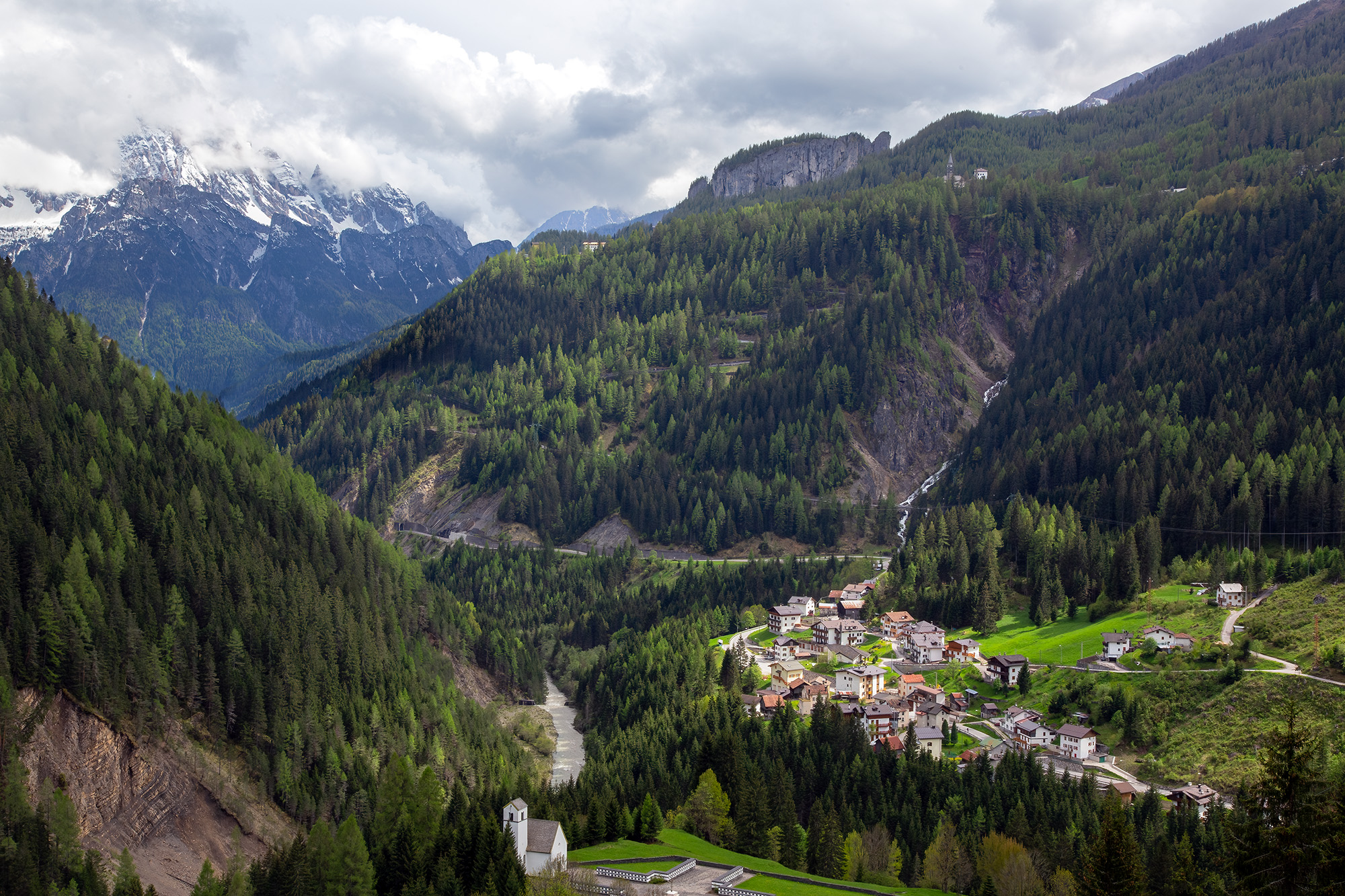 High above the Italian Dolomites, this image frames the town of Tusele against a backdrop of nature's might. The village nestles...