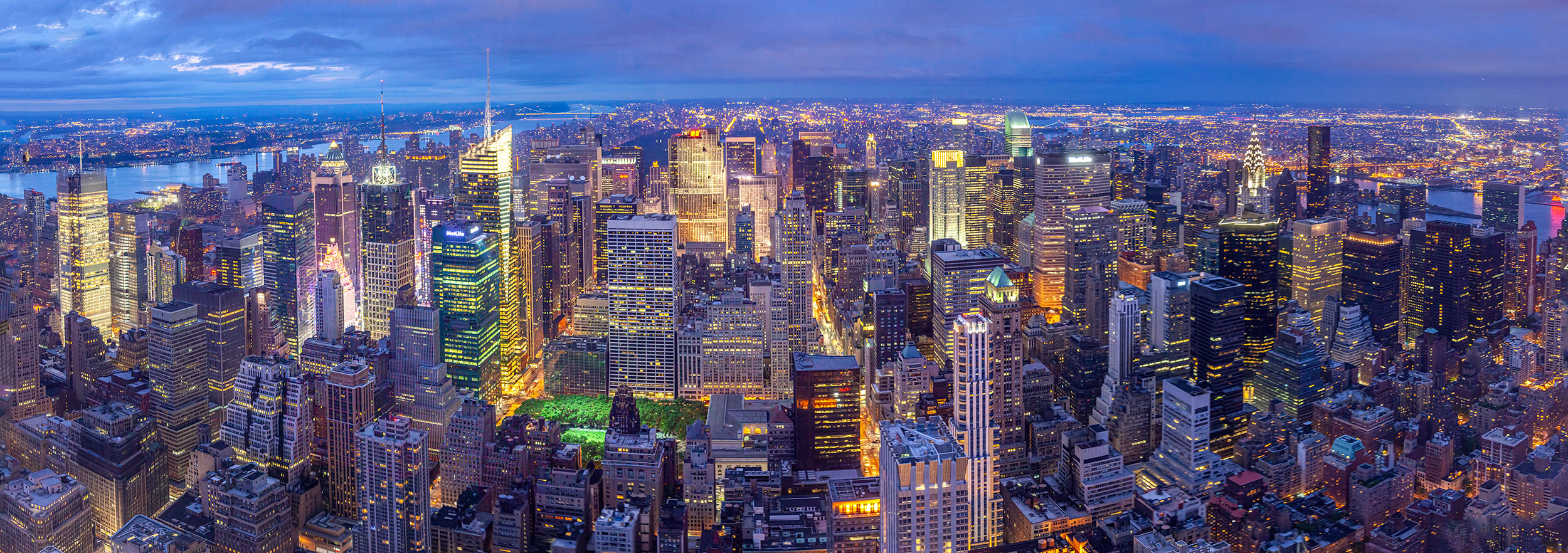 This 9-image stitched panoramic was captured from the pinnacle of the Empire State Building during the enchanting blue hour....