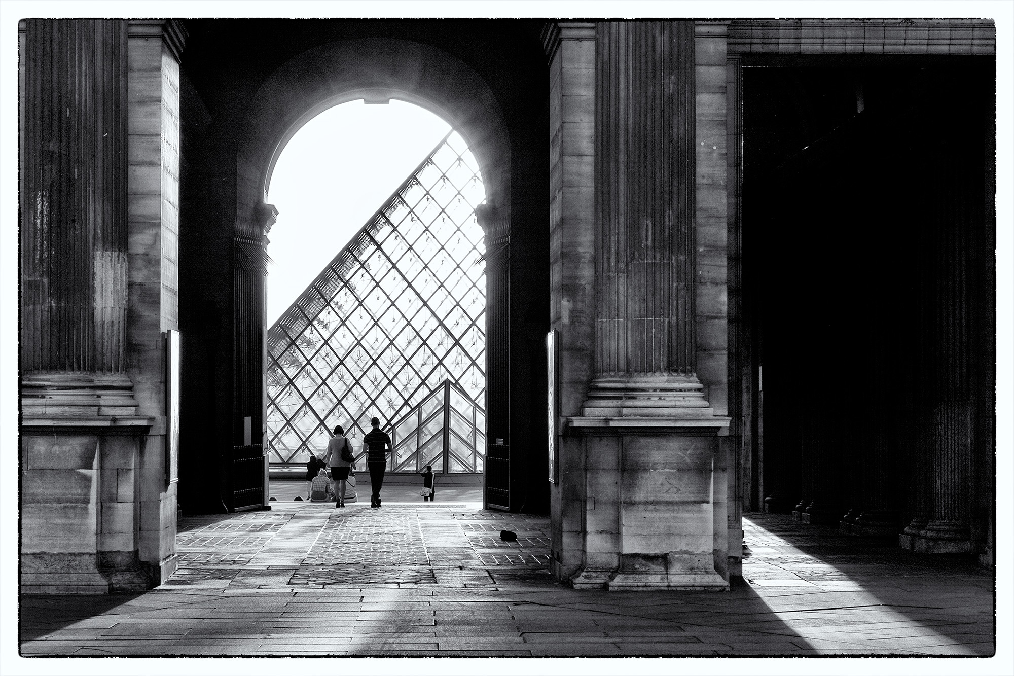 Elegance in Shadows "Elegance in Shadows" is a monochromatic composition captured within the hallways surrounding Paris's iconic Louvre. The interplay...