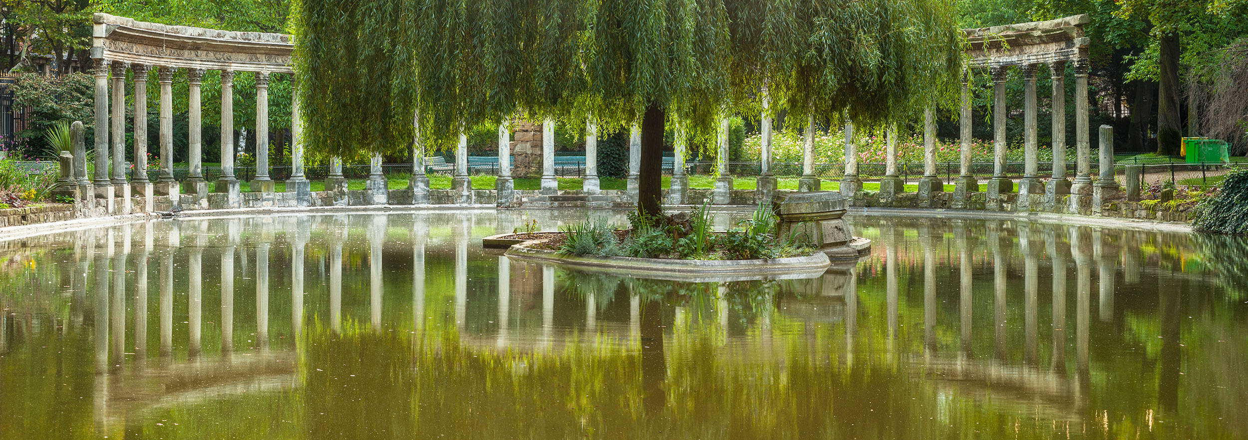 "Reflections at Parc Monceau" is a panoramic image captured from the serene Parc Monceau in the heart of Paris, France. At its...