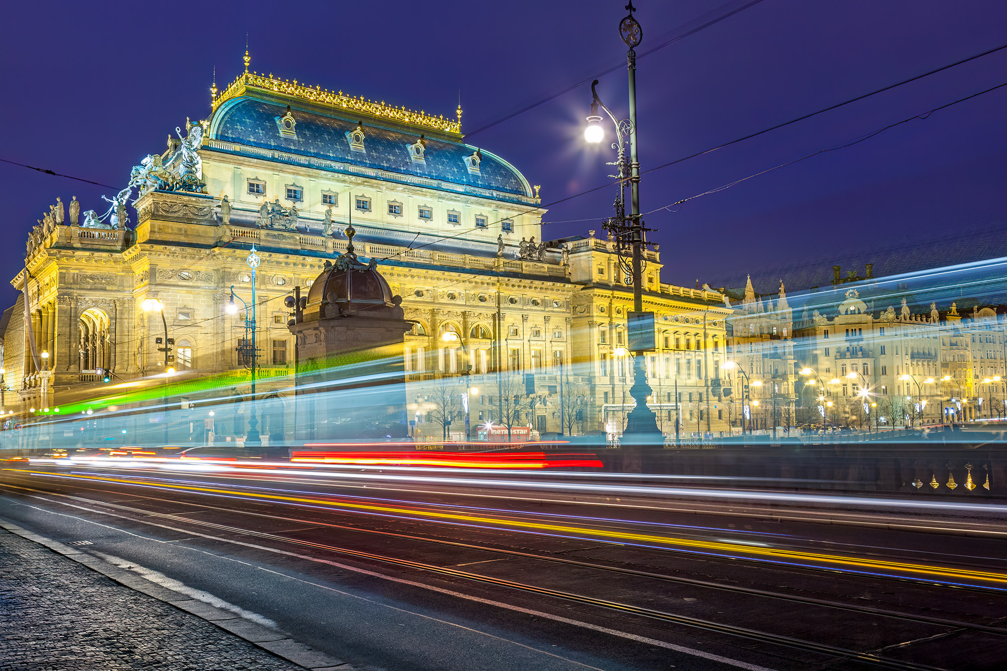 Set against the enchanting backdrop of Prague's National Theatre, this image captures the grandeur of the cultural institution...