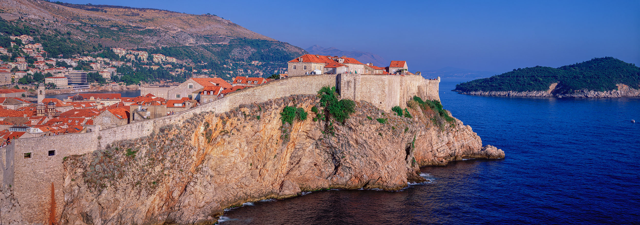 "Dubrovnik's Coastal Splendor" presents a captivating horizontal view of the ancient medieval village of Dubrovnik, Croatia...