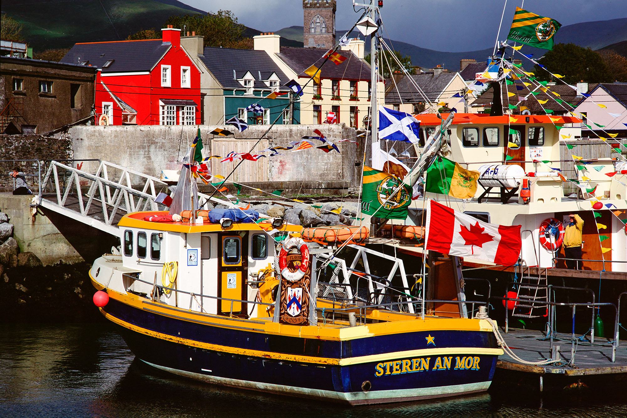 Captured with my Bronica ETRSi camera on Fuji Velvia Film, this image unveils the vibrant beauty of Dingle Harbor, Ireland. The...