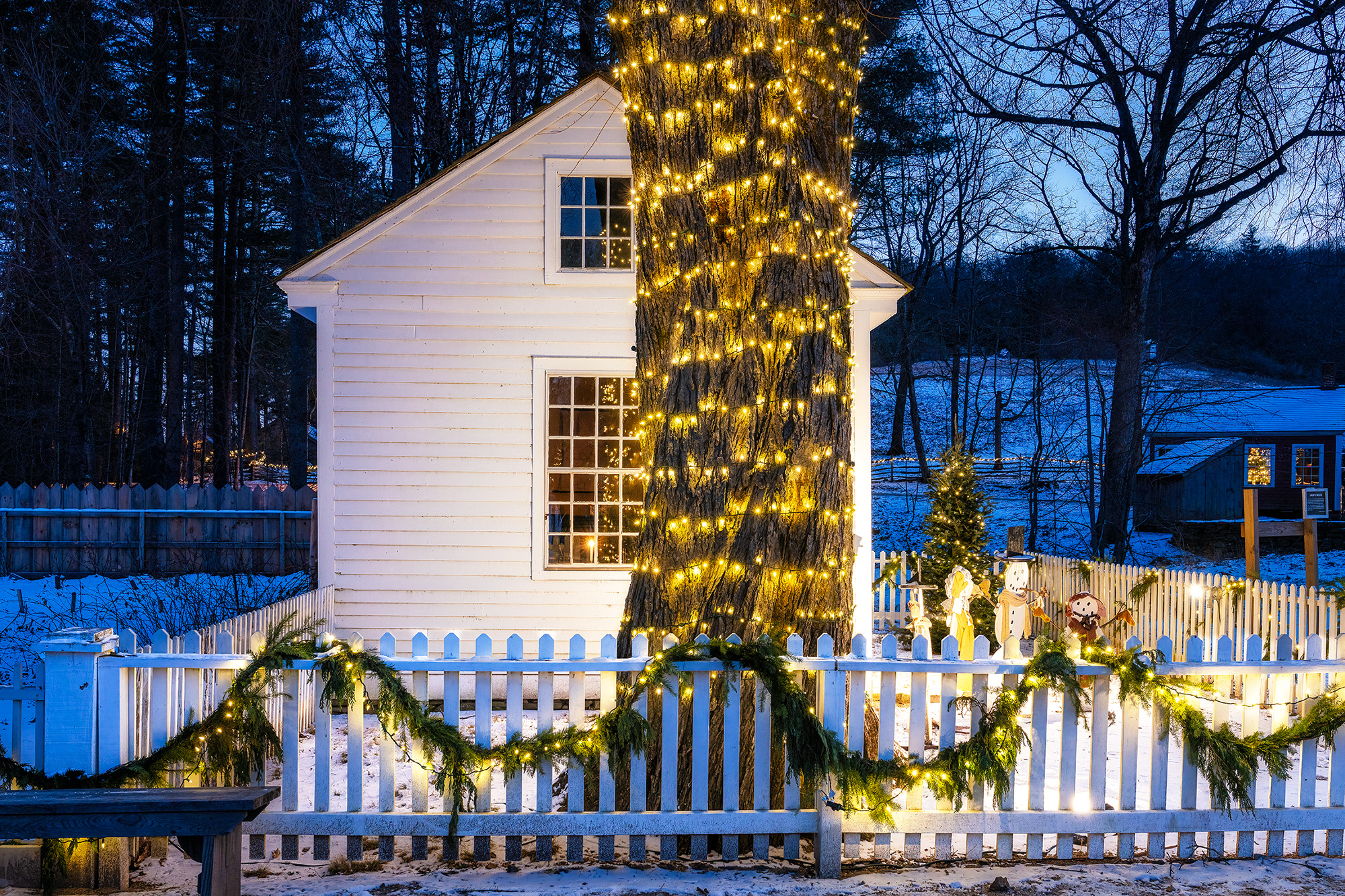 Festive Glow in Old Sturbridge Village This blue hour image captures the festive charm of Old Sturbridge Village in Massachusetts during a frigid, snowy Christmas season...